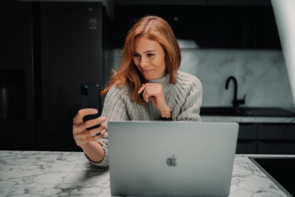 a woman sitting in front of a laptop computer