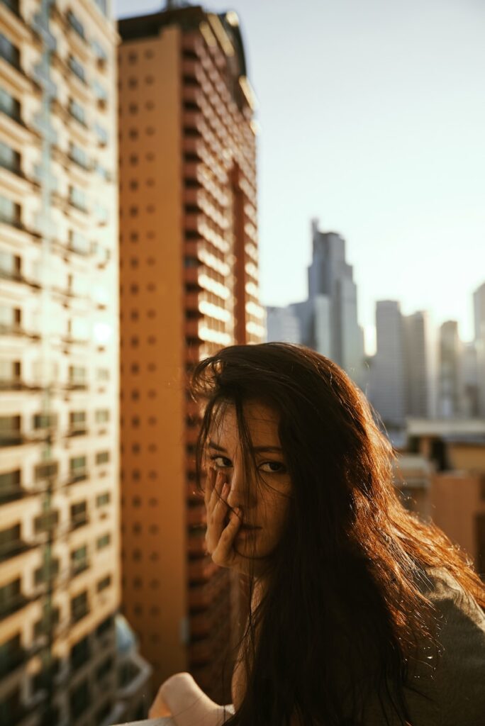 woman in gray top beside building