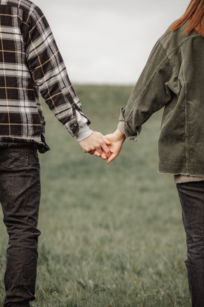 man in black and white plaid dress shirt and gray pants holding hands with woman in in on on on