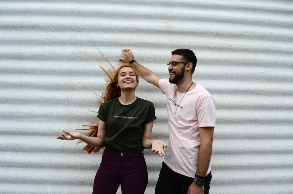 man and woman standing while chatting