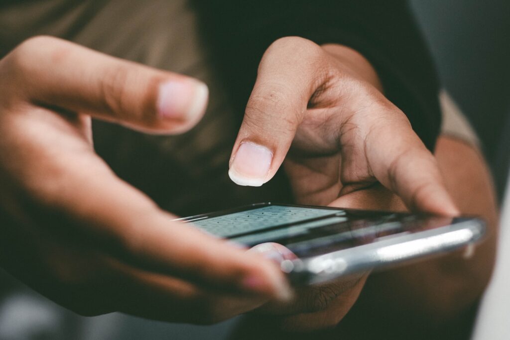 a close up of a person holding a cell phone