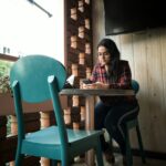 woman leaning on pedestal table